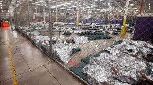 Detainees sleep and watch television in a holding cell where hundreds of mostly Central American immigrant children are being processed and held at the U.S. Customs and Border Protection Nogales Placement Center on June 18, 2014, in Nogales, Arizona. Ross D. Franklin-Pool/Getty Images